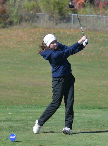 Detroit Country Day's Halle Heineman follows her drive.