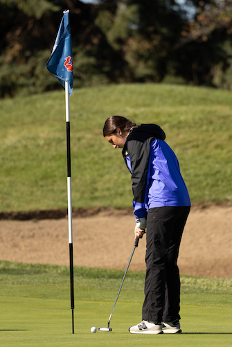 A golfer follows through on a short putt during the MHSAA Finals.