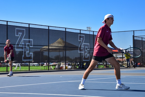 Tanis prepares to serve with Gorno playing the net. 