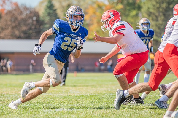 Ryan Hrachovina (25) works to get around a Holton blocker. 
