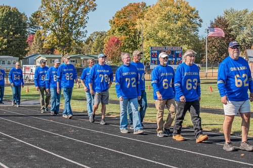Members of the 1976 Onekama team walk toward the field at the new stadium. 