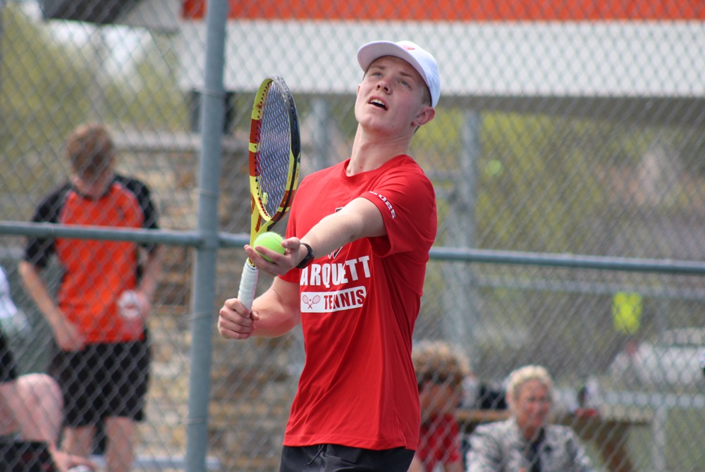 Marquette’s Chase Thomsen prepares to serve during a match Wednesday at No. 1 singles.