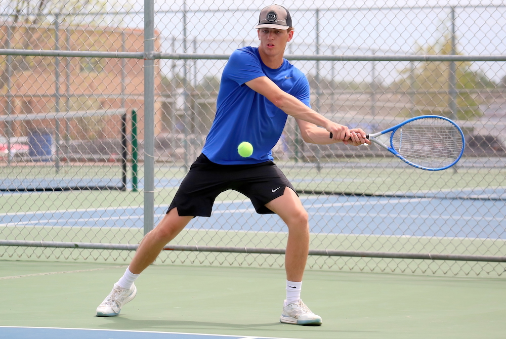 West Iron County's Elijah Oberlin returns a volley during a No. 1 doubles match Wednesday.